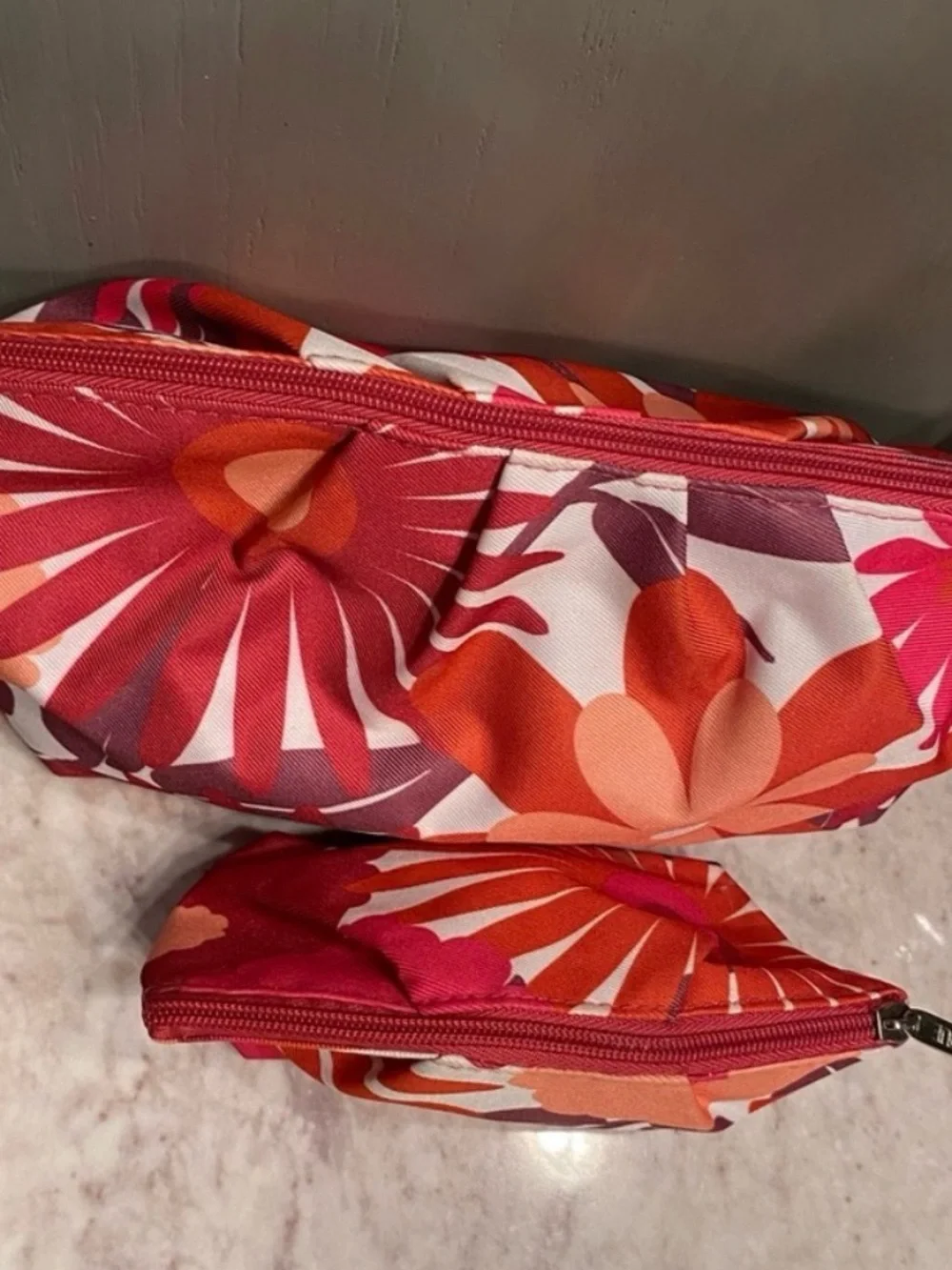 Clinique maroon, orange, pink, and white floral makeup bags #makeup #floral